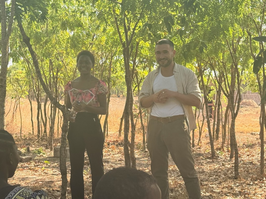 Matthew Hopkinson and a community leader during an outdoor coaching session