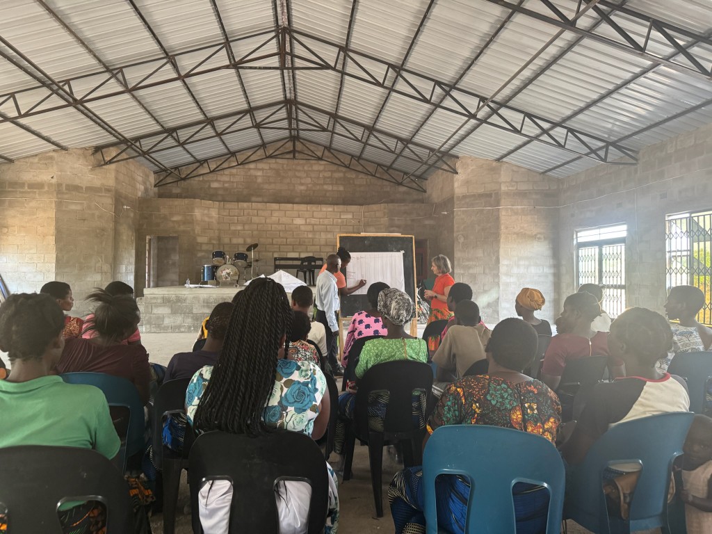 Facilitators leading a community planning session at a flipchart
