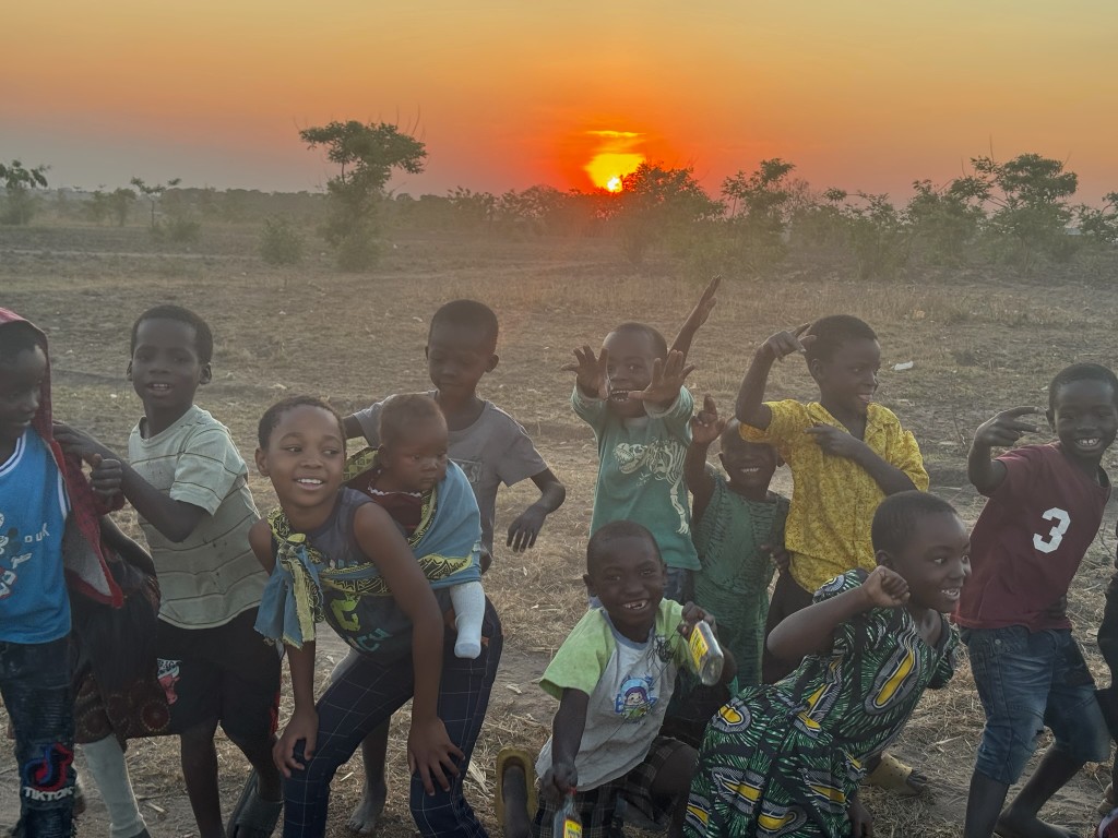 Children playing together at sunset in Malawi